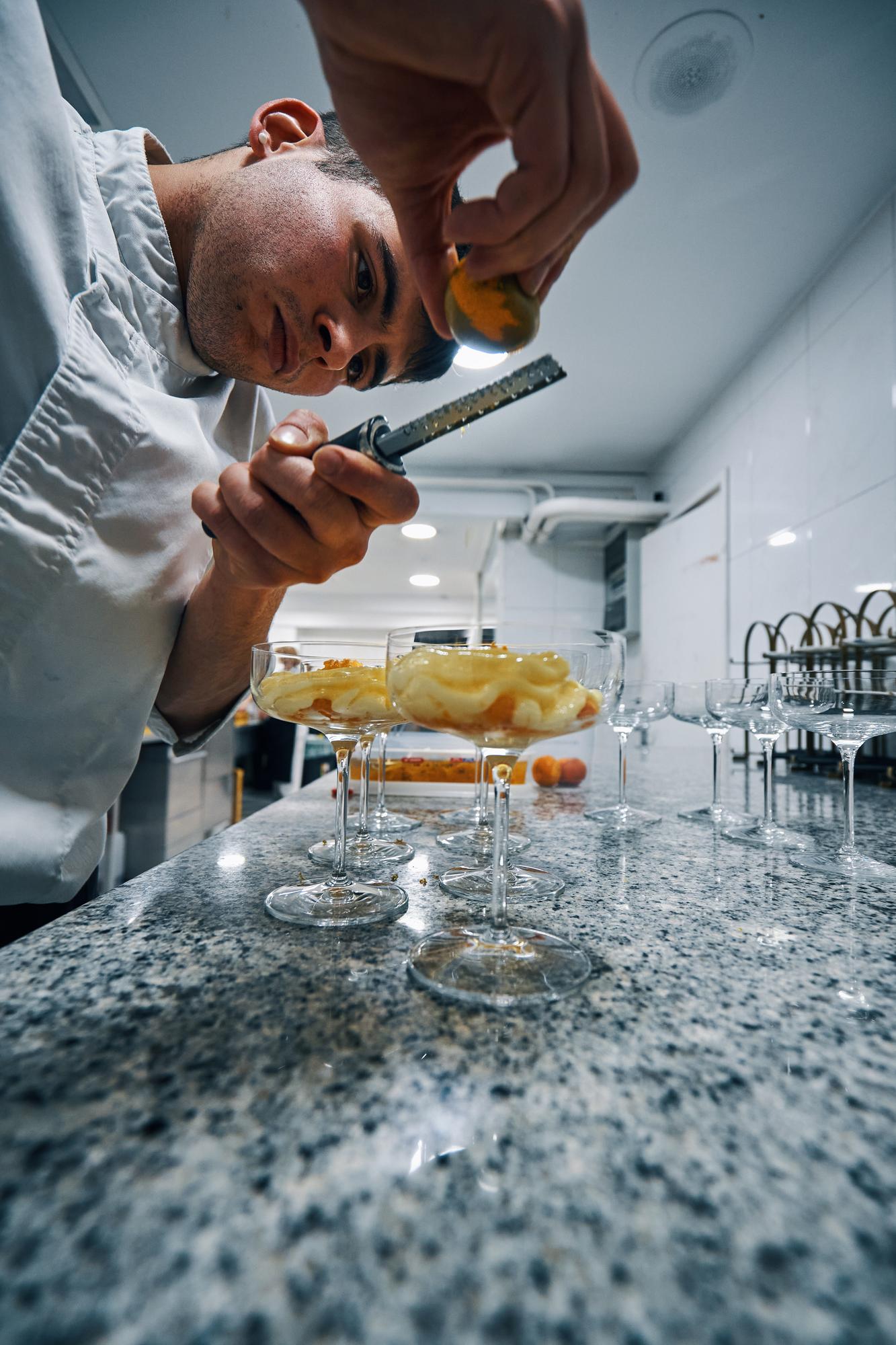 Chef testing molecular techniques in chrome kitchen